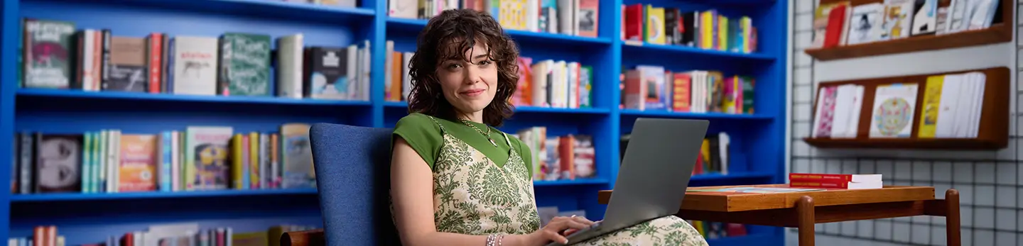 Tatiana, a real person with narcolepsy with cataplexy taking WAKIX, sitting with their laptop